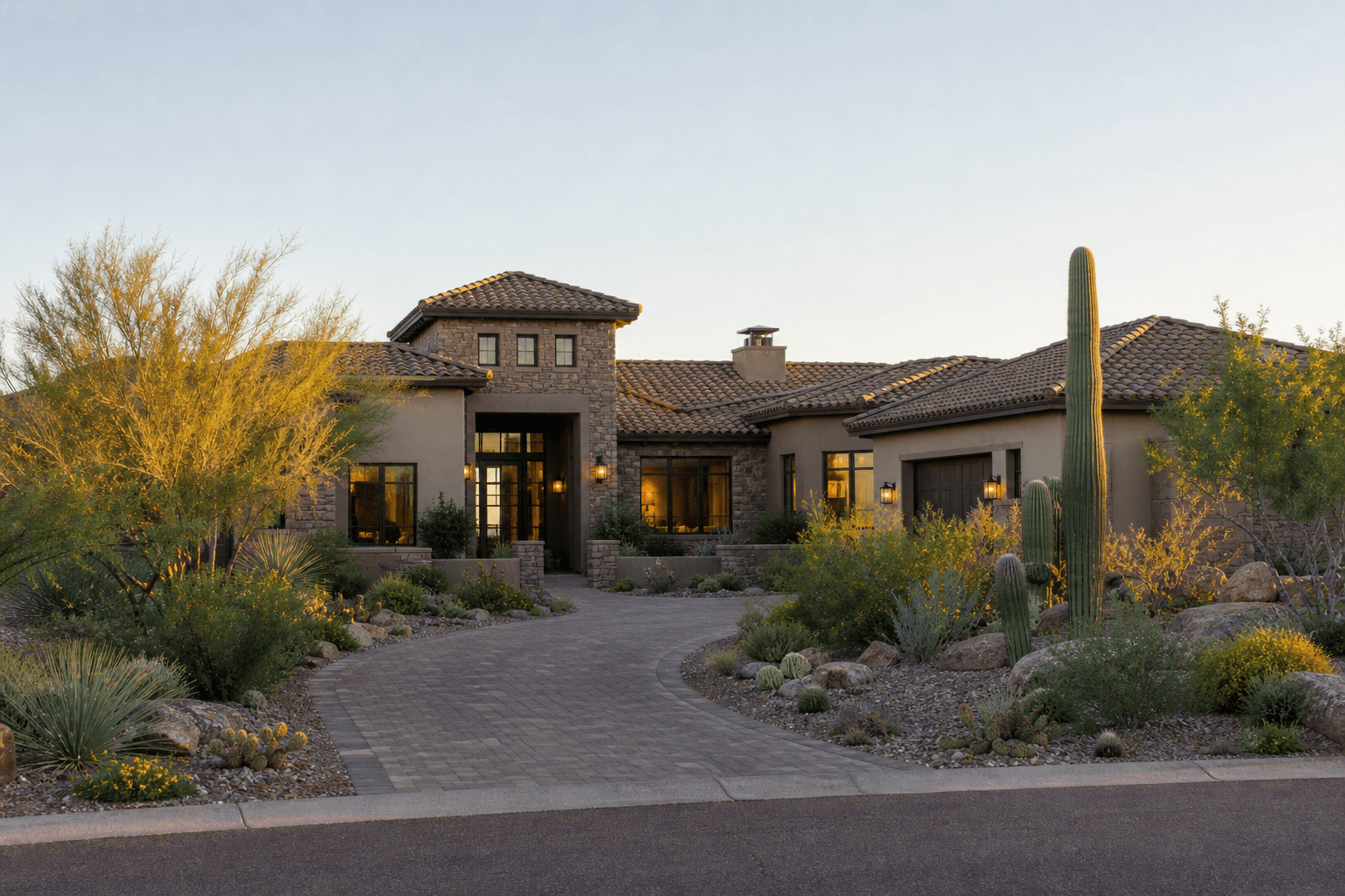 Completed estate home with clay or concrete tile roof in desert landscaping.